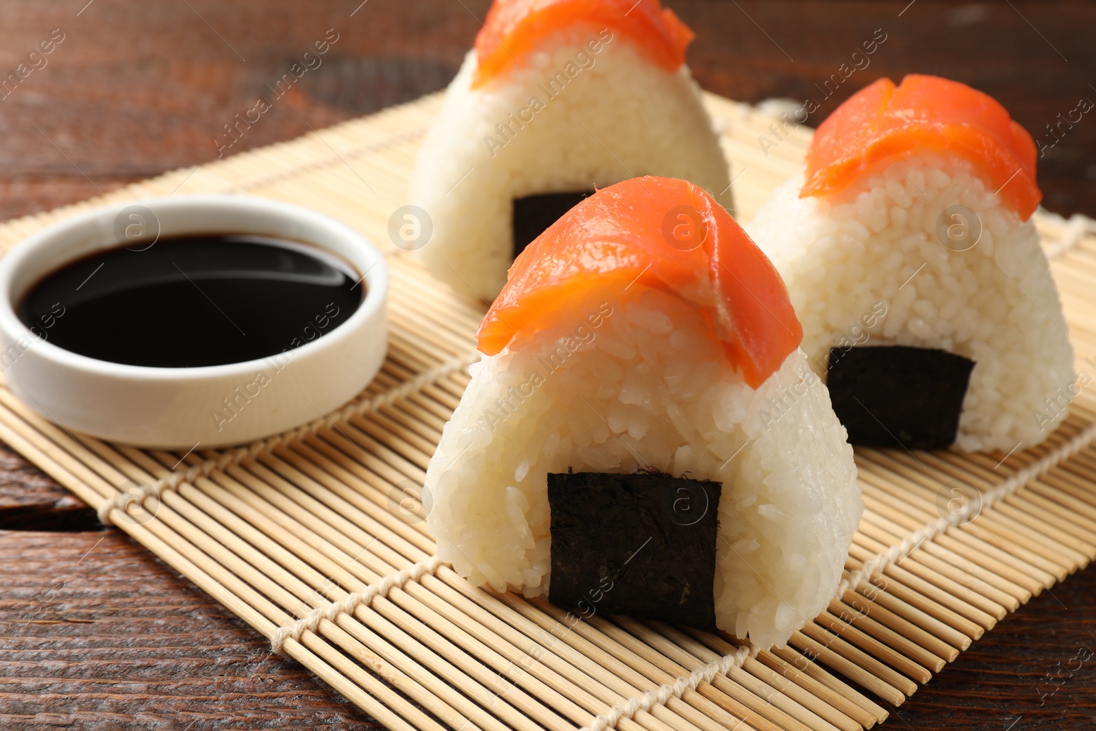 Tasty onigiri (Japanese rice balls) served on wooden table, closeup Photo of Tasty onigiri (Japanese rice balls) served on wooden table, closeup