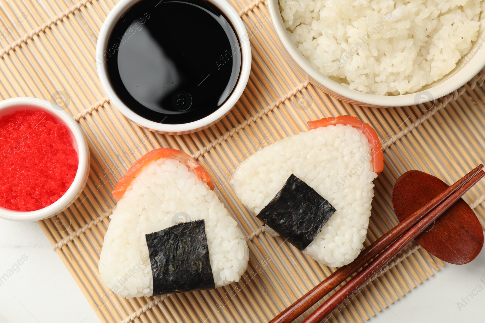 Tasty onigiri (Japanese rice balls) served on white table, flat lay Photo of Tasty onigiri (Japanese rice balls) served on white table, flat lay