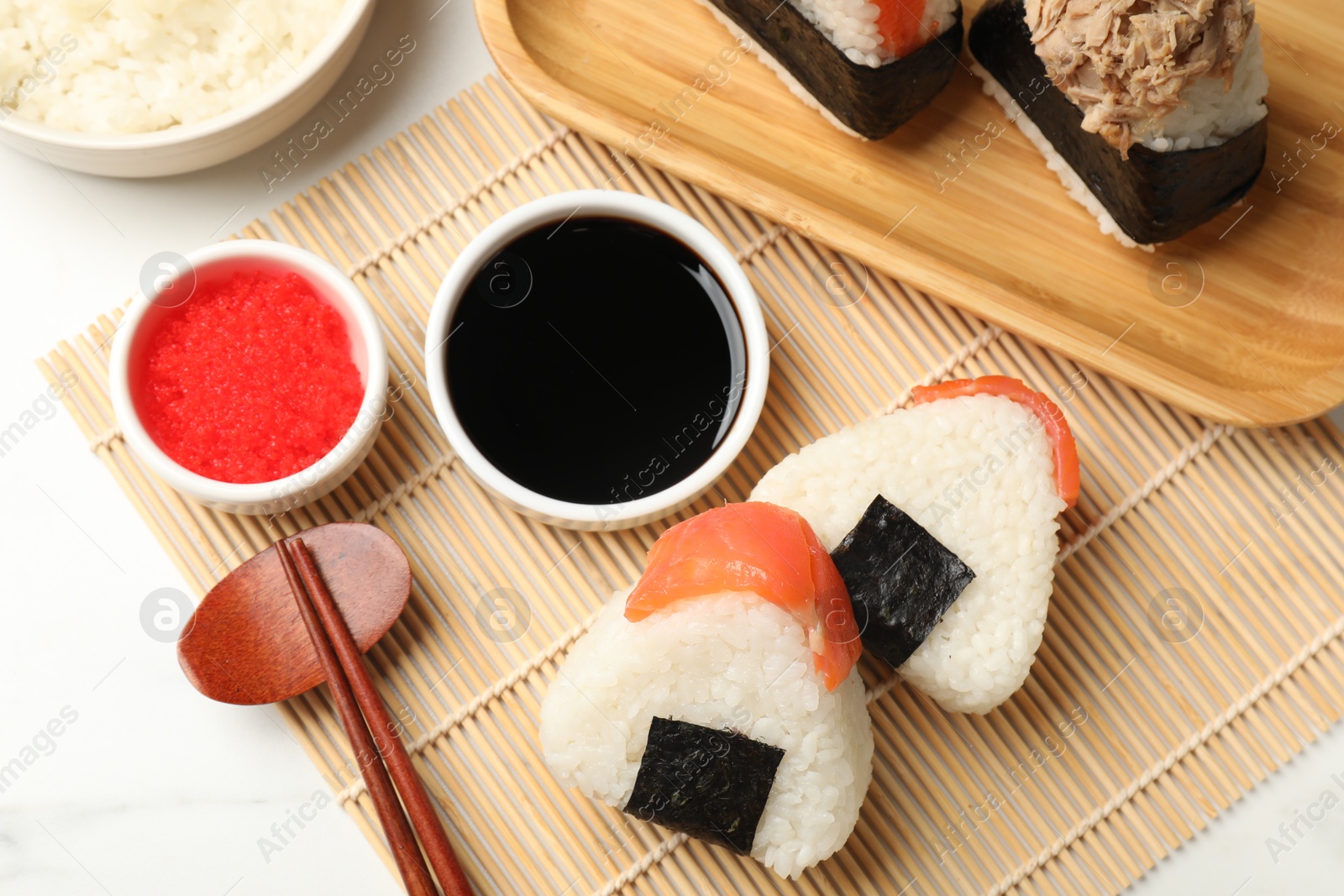 Tasty onigiri (Japanese rice balls) served on white table, flat lay Photo of Tasty onigiri (Japanese rice balls) served on white table, flat lay
