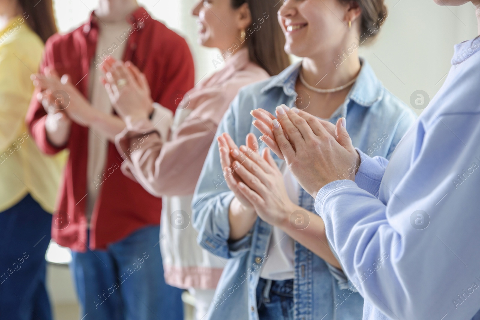 Photo of People applauding during meeting indoors, closeup view