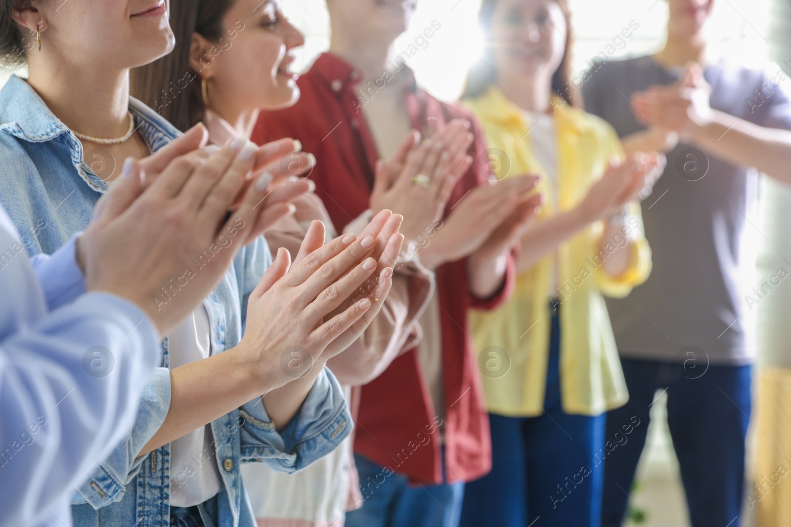 Photo of People applauding during meeting indoors, closeup view