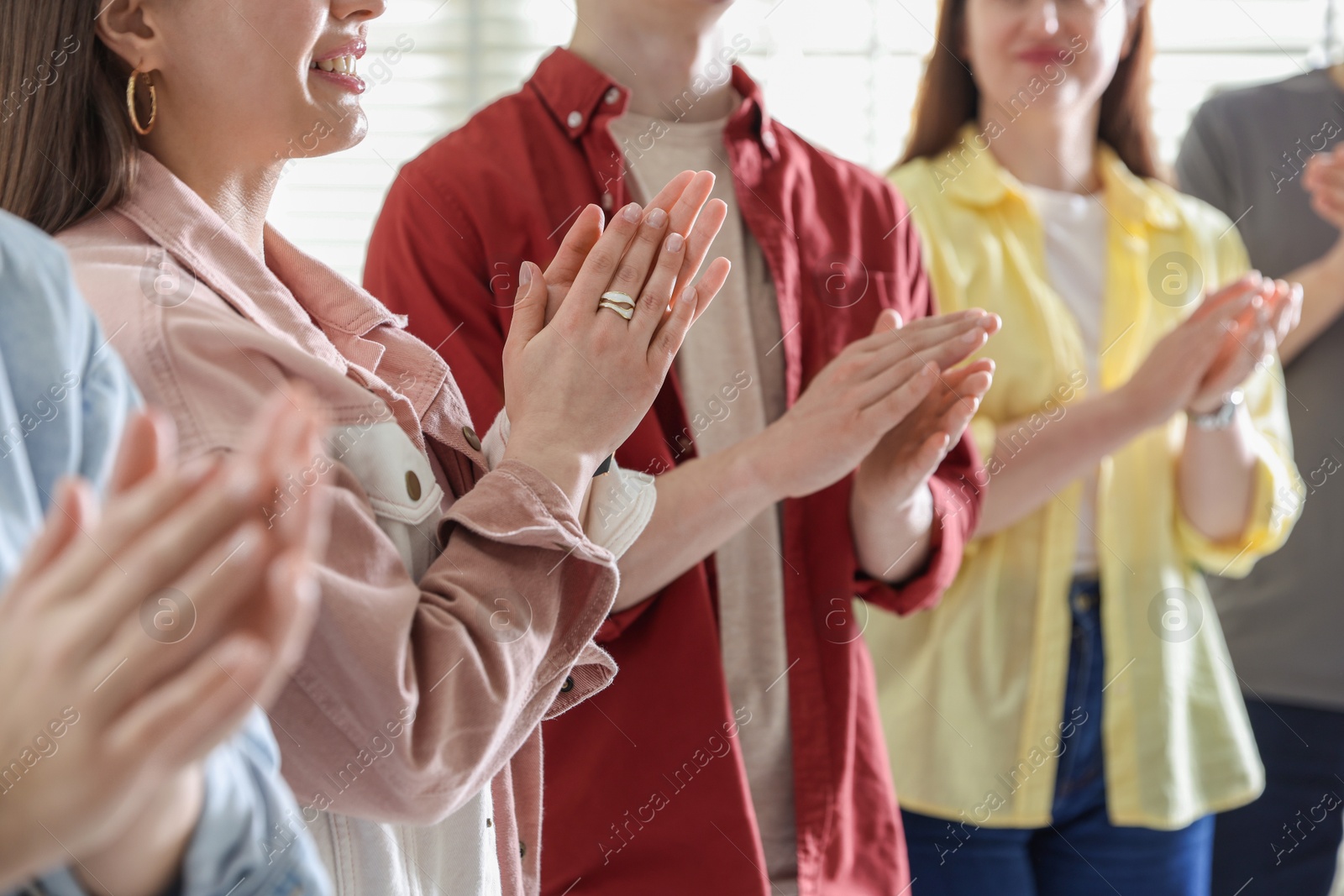 Photo of People applauding during meeting indoors, closeup view