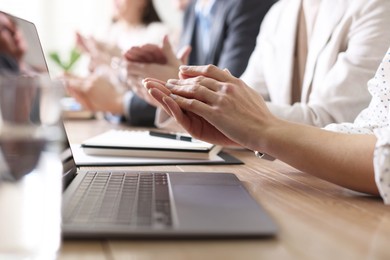 Photo of People applauding at table in office, closeup