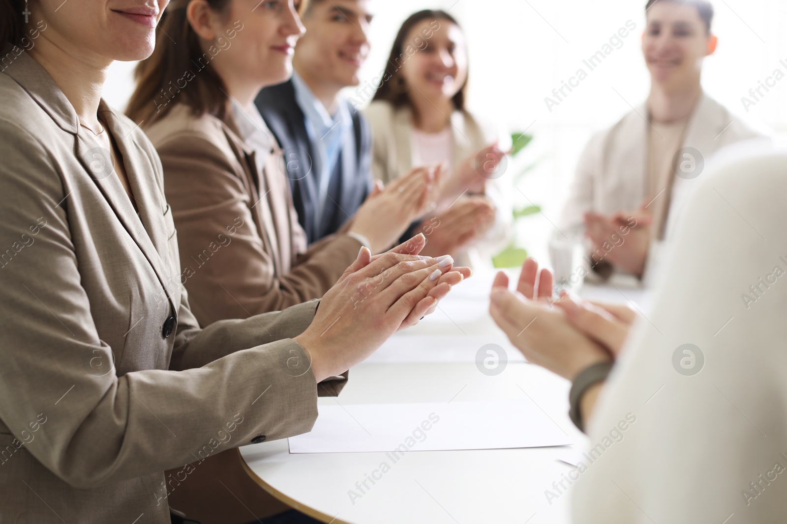 Photo of People applauding at table in office, closeup