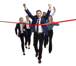 Photo of Competition concept. Happy businessman crossing red finish line ahead of his colleagues on white background