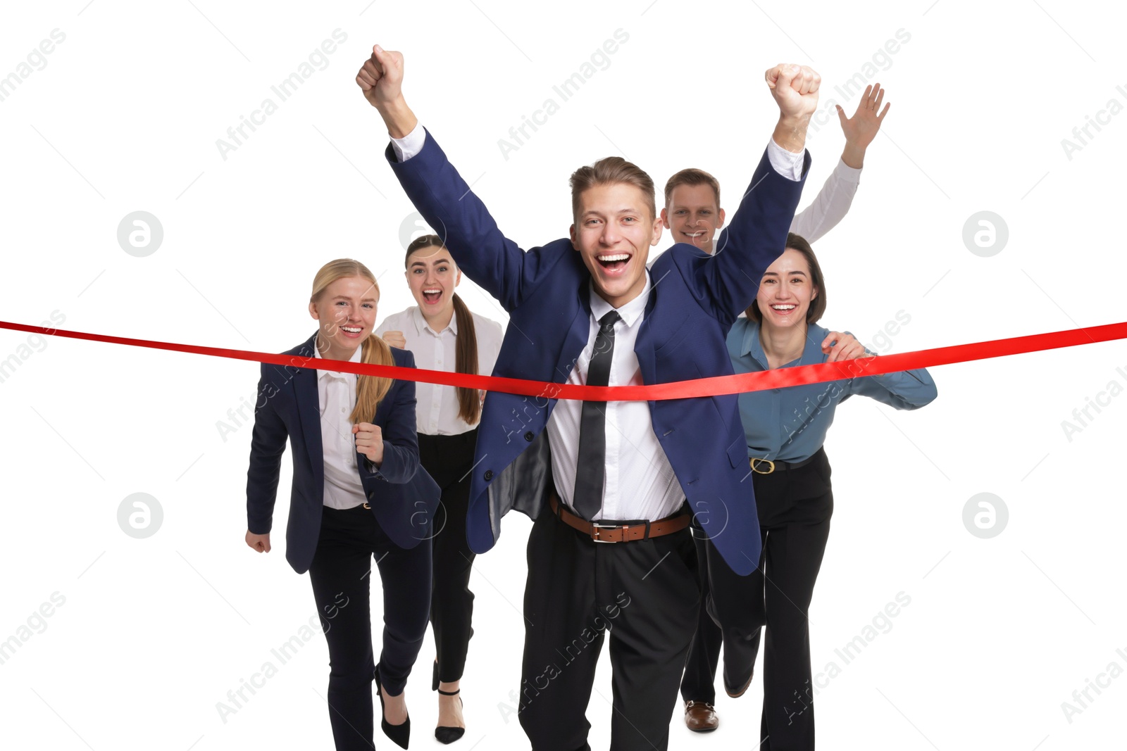 Photo of Competition concept. Happy businessman crossing red finish line ahead of his colleagues on white background