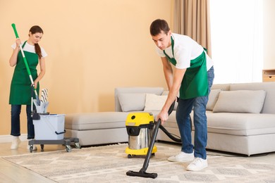 Professional cleaning service team working in room