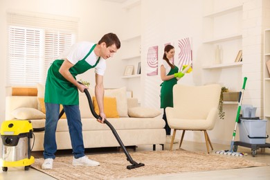 Professional cleaning service team working in room