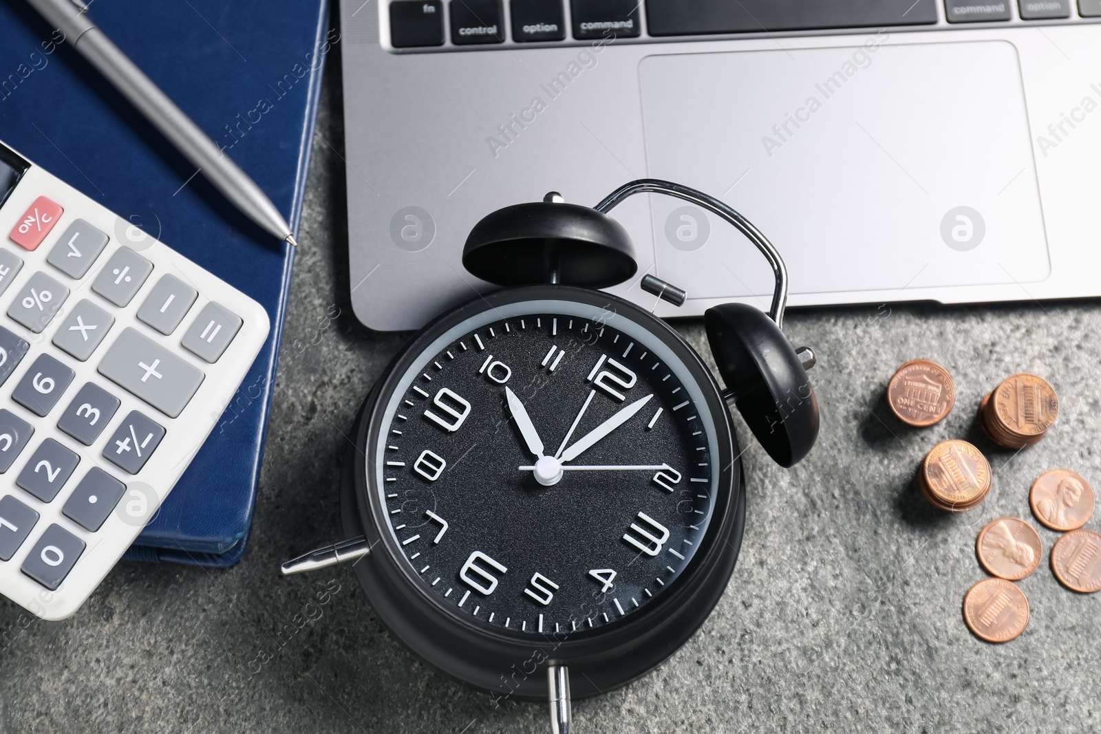 Photo of Time to pay taxes. Alarm clock, laptop, calculator, coins and notebook on grey textured table, flat lay