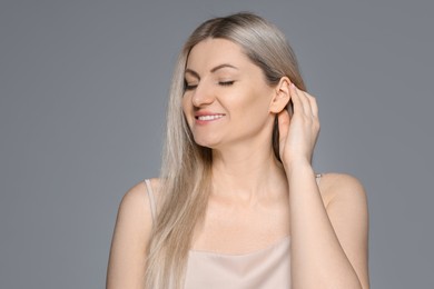 Photo of Portrait of beautiful woman on grey background