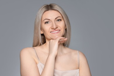 Photo of Portrait of beautiful woman on grey background