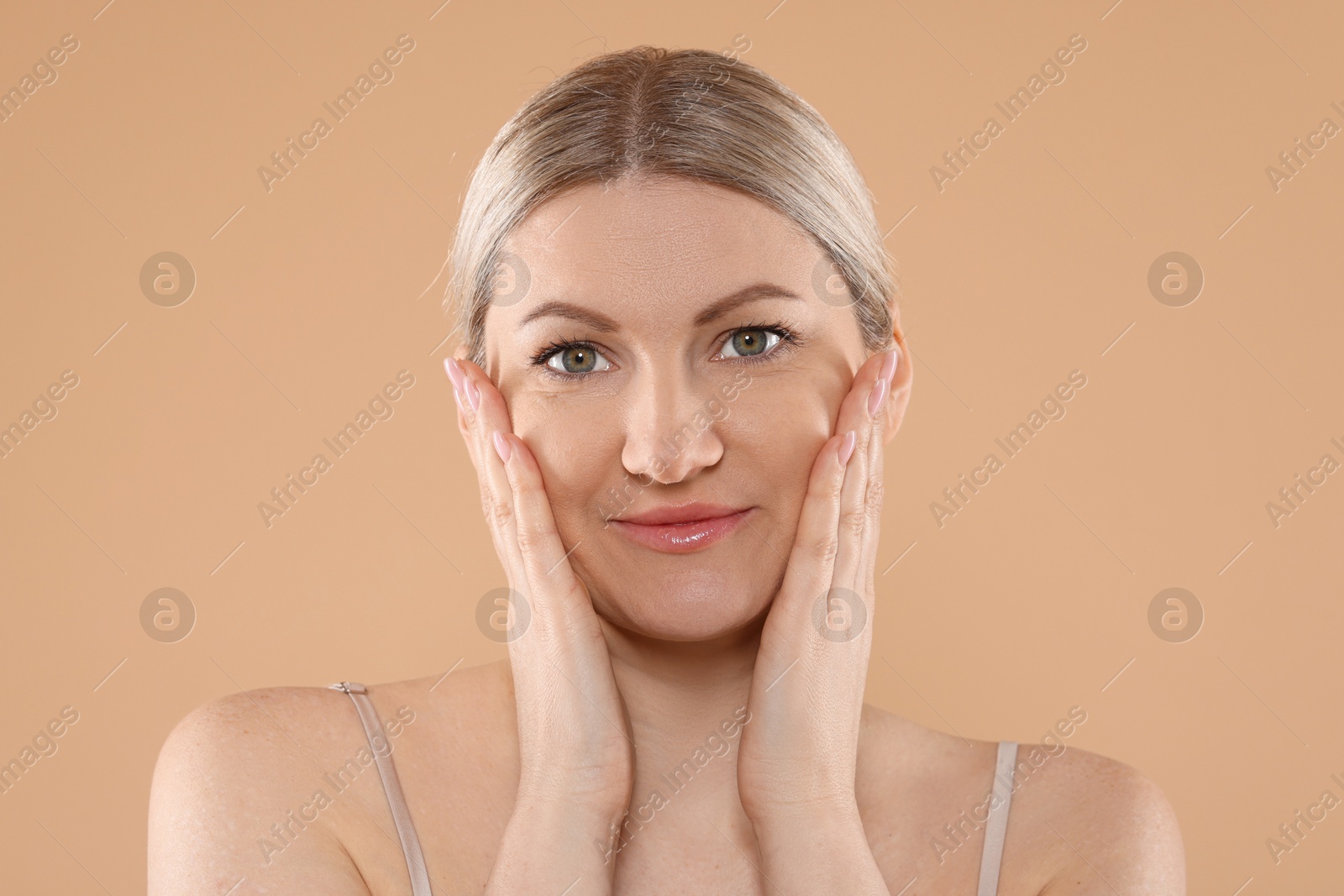 Photo of Portrait of beautiful woman on beige background