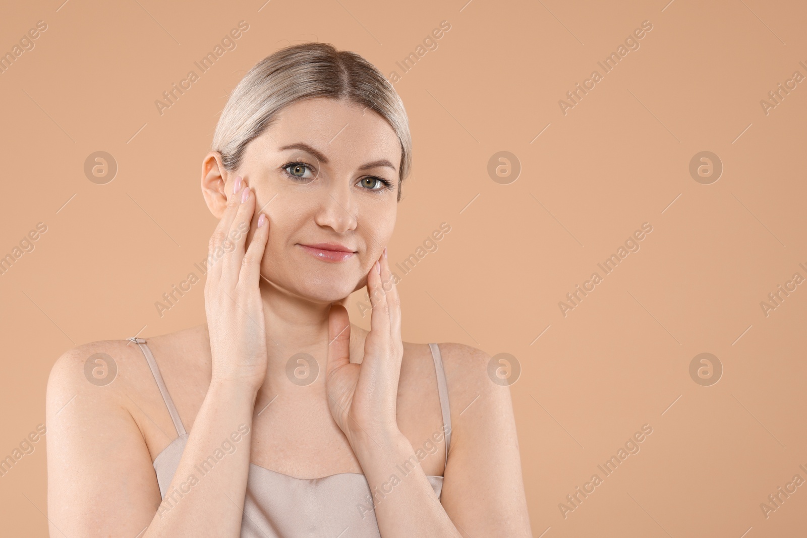 Photo of Portrait of beautiful woman on beige background. Space for text