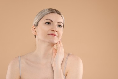 Photo of Portrait of beautiful woman on beige background. Space for text