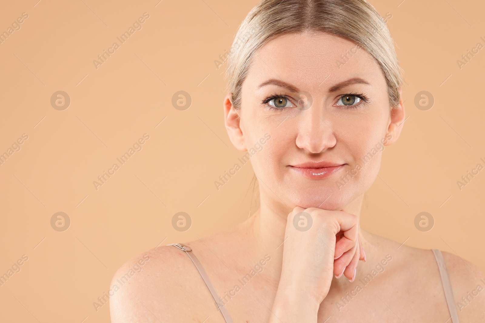 Photo of Portrait of beautiful woman on beige background. Space for text