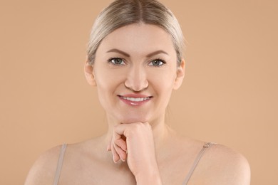 Photo of Portrait of beautiful woman on beige background