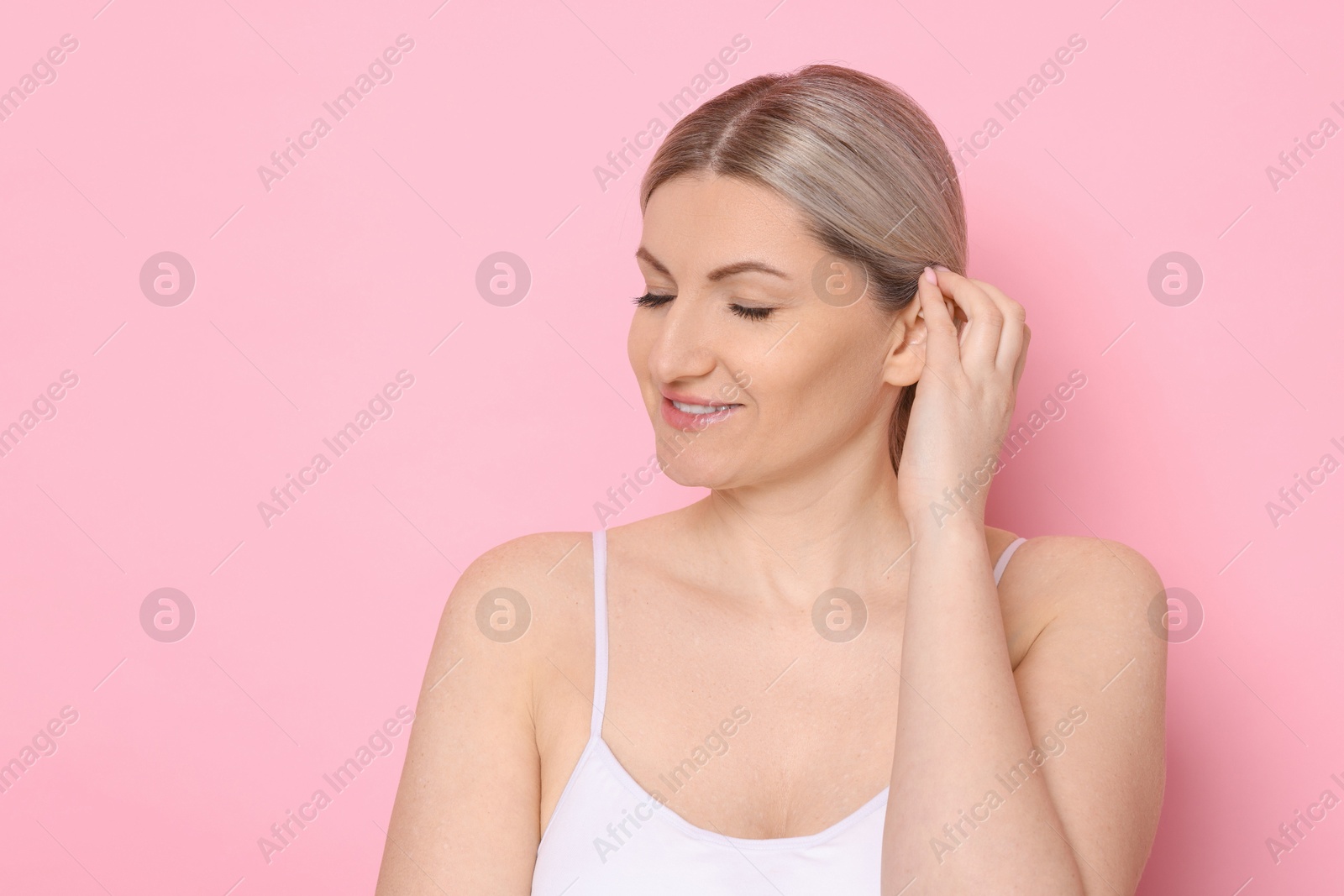 Photo of Portrait of beautiful woman on pink background. Space for text