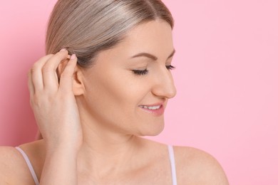 Photo of Portrait of beautiful woman on pink background