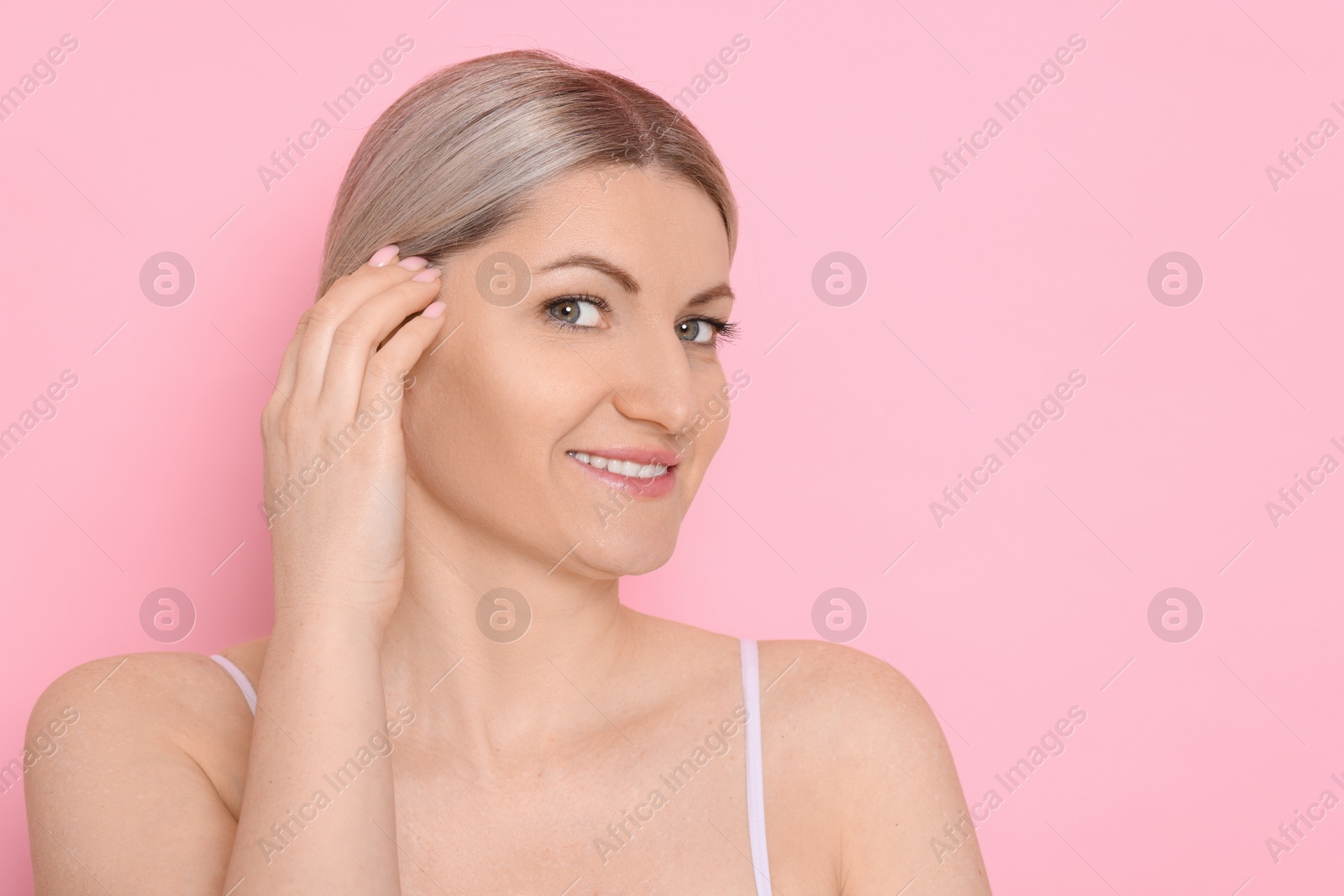 Photo of Portrait of beautiful woman on pink background. Space for text