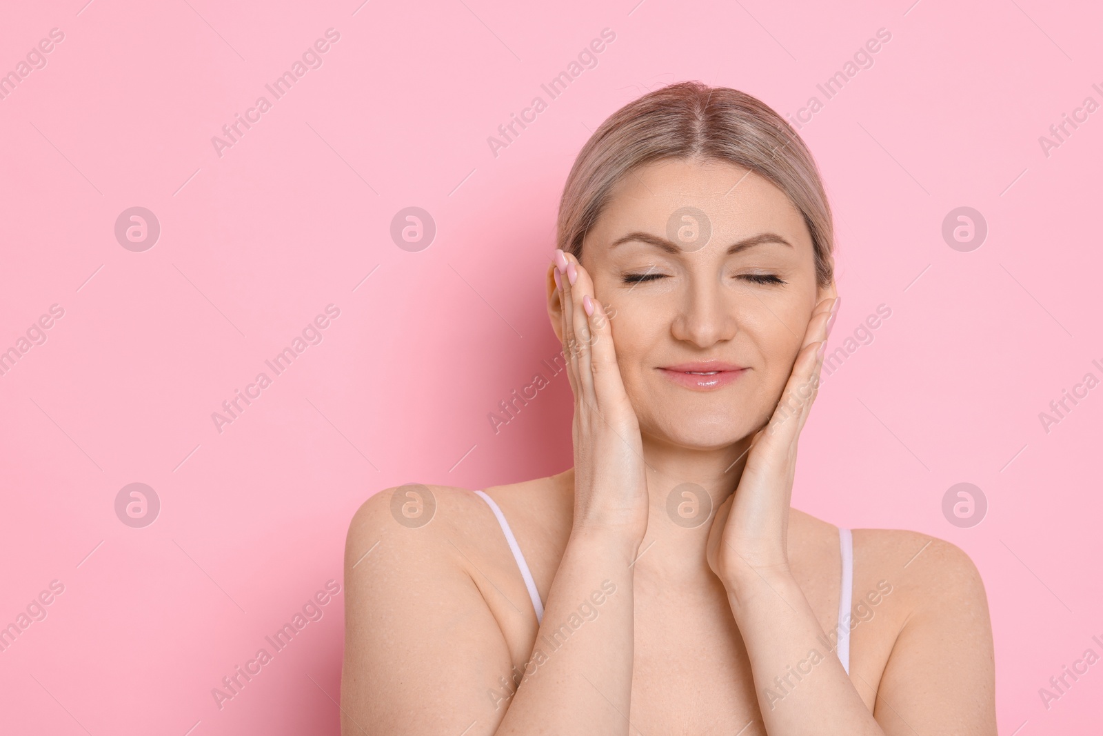 Photo of Portrait of beautiful woman on pink background. Space for text