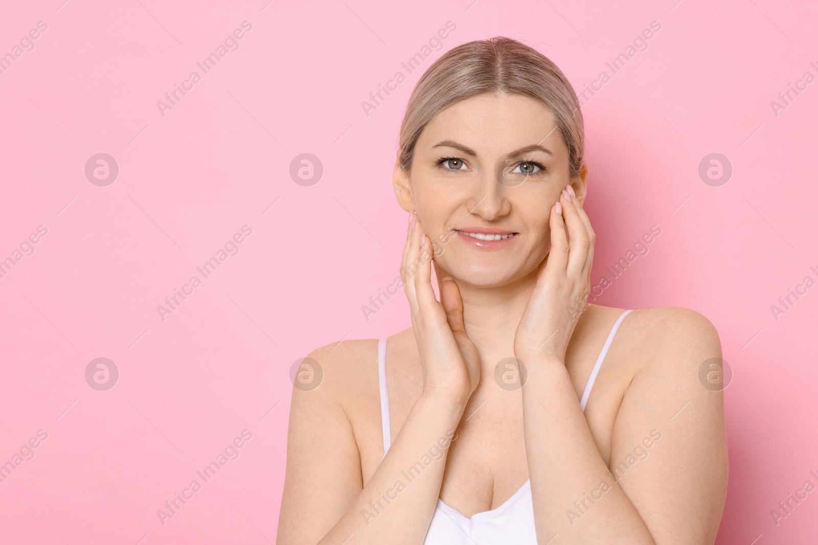 Photo of Portrait of beautiful woman on pink background. Space for text