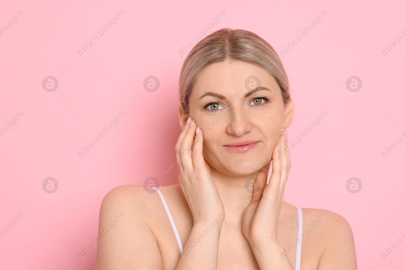 Photo of Portrait of beautiful woman on pink background