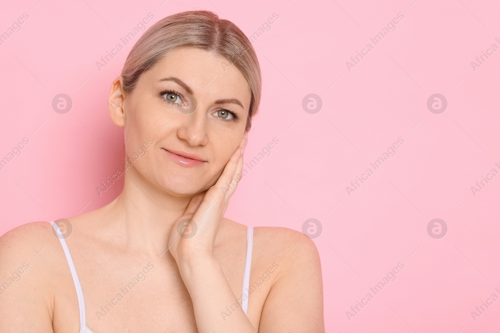 Photo of Portrait of beautiful woman on pink background. Space for text