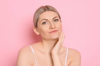 Portrait of beautiful woman on pink background