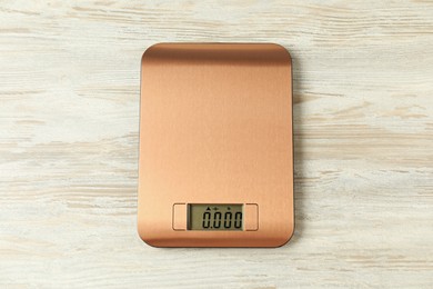 Photo of Modern electronic kitchen scale on wooden table, top view