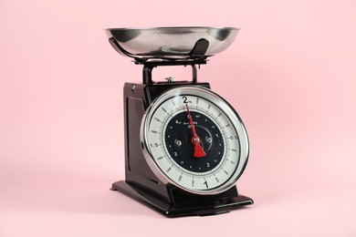 Photo of One mechanical kitchen scale on pink background