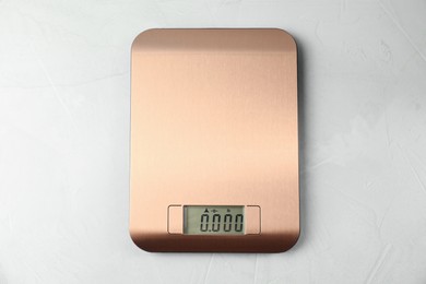 Photo of One electronic kitchen scale on grey textured table, top view