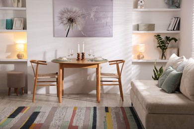 Photo of Stylish table setting, chairs and sofa in dining room. interior design