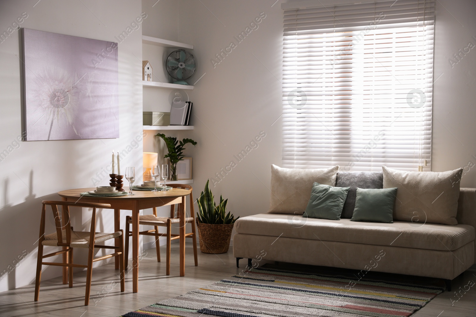 Photo of Stylish table setting, chairs and sofa in dining room. interior design