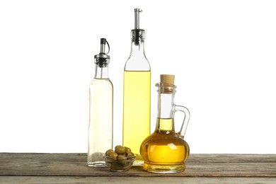 Photo of Salad dressings and olives on wooden table against white background