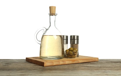 Photo of Vinegar, spices and olives on wooden table against white background