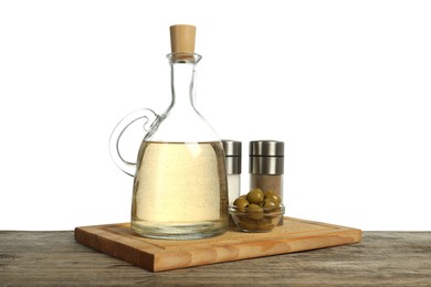 Photo of Vinegar, spices and olives on wooden table against white background