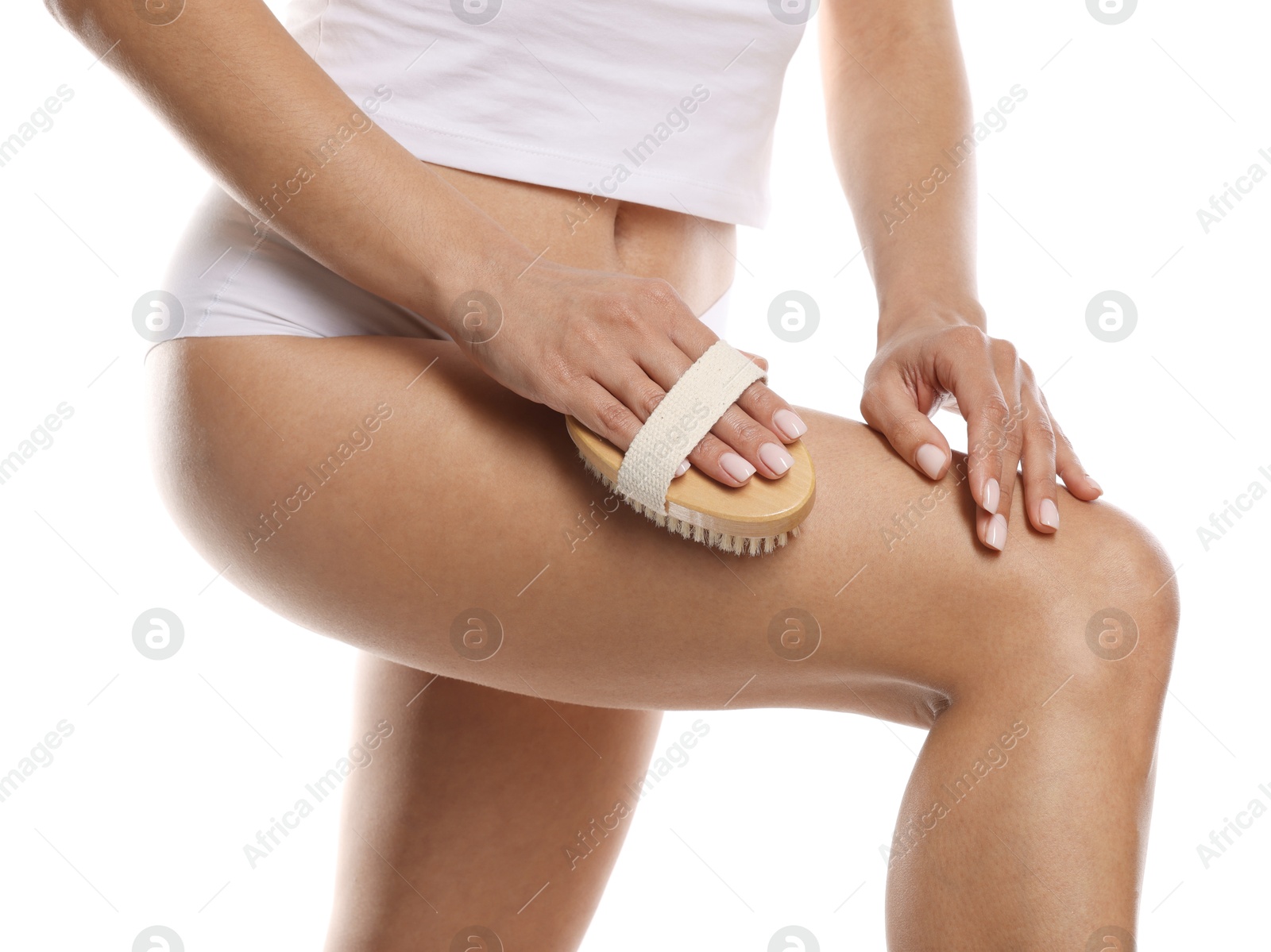 Photo of Woman doing anti cellulite massage with brush on white background, closeup