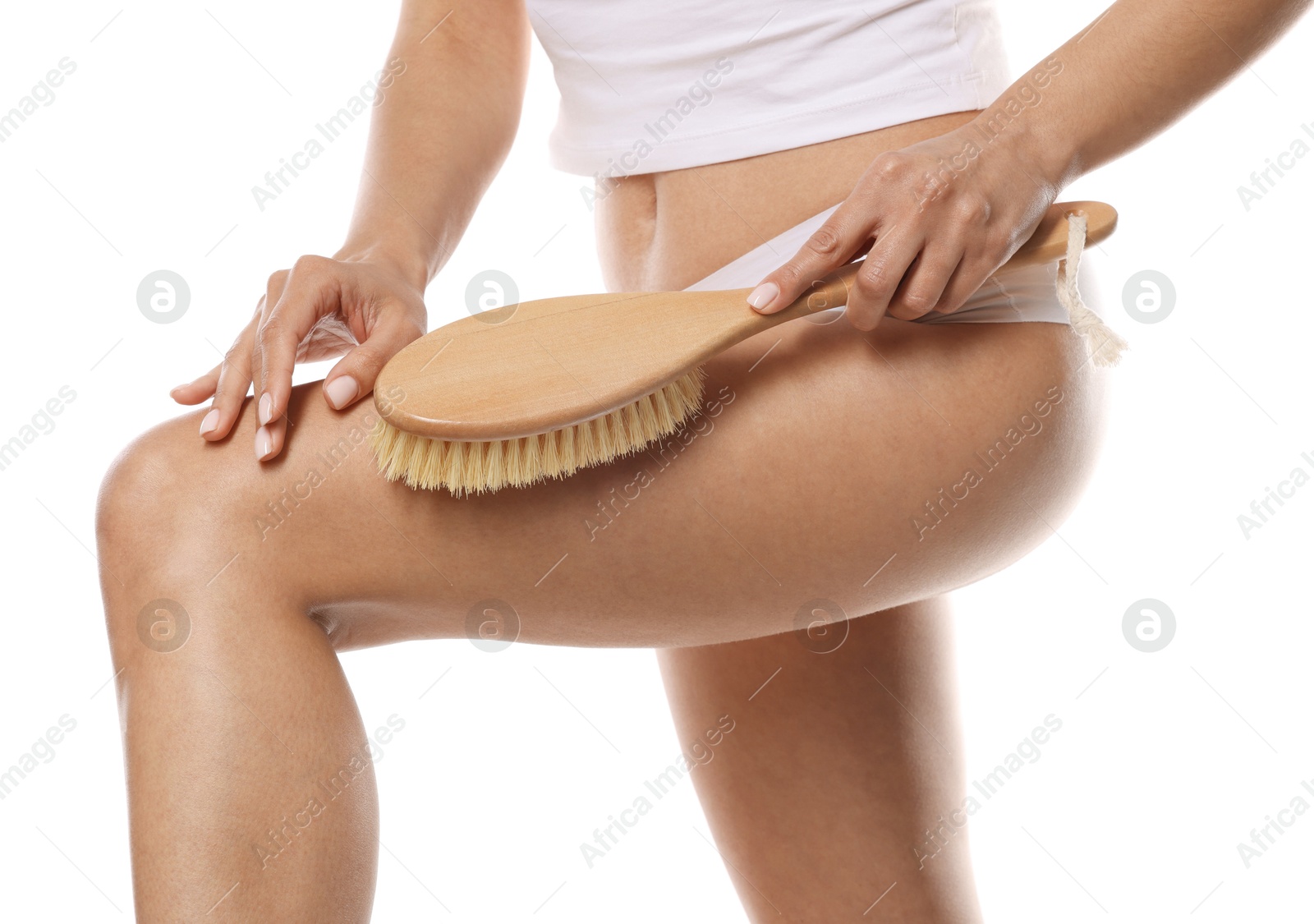 Photo of Woman doing anti cellulite massage with brush on white background, closeup