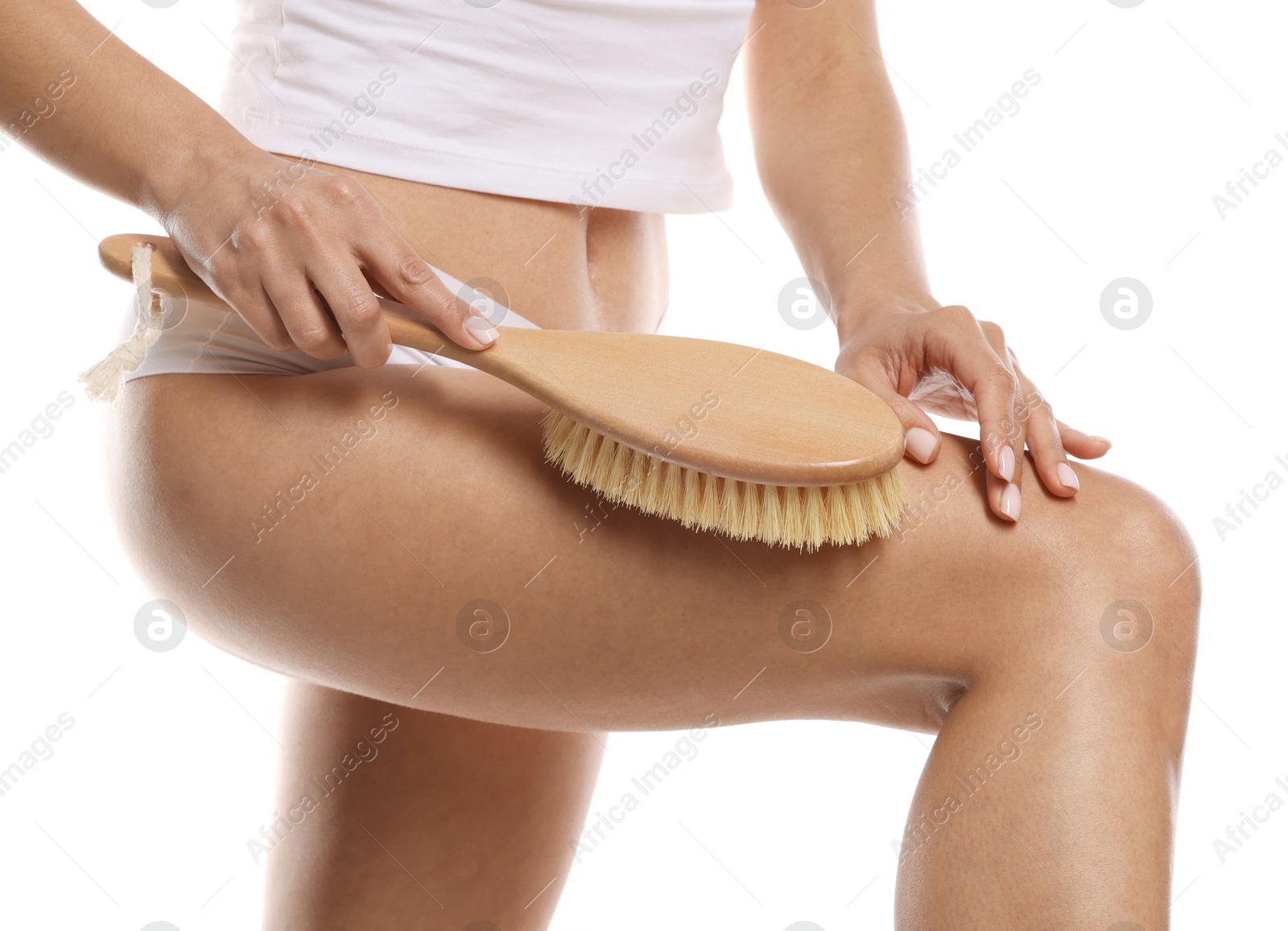 Photo of Woman doing anti cellulite massage with brush on white background, closeup