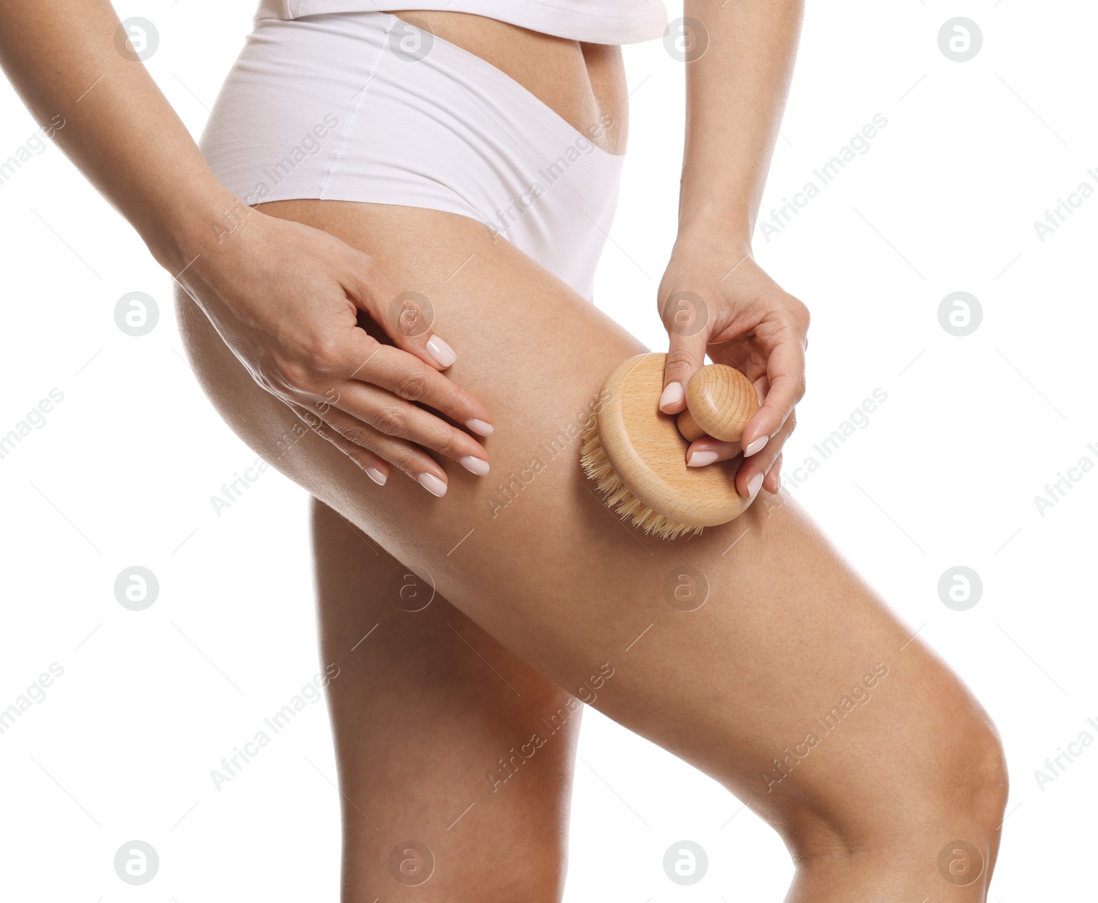 Photo of Woman doing anti cellulite massage with brush on white background, closeup