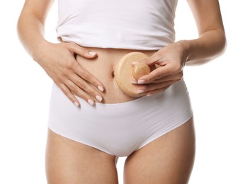 Woman doing anti cellulite massage with brush on white background, closeup