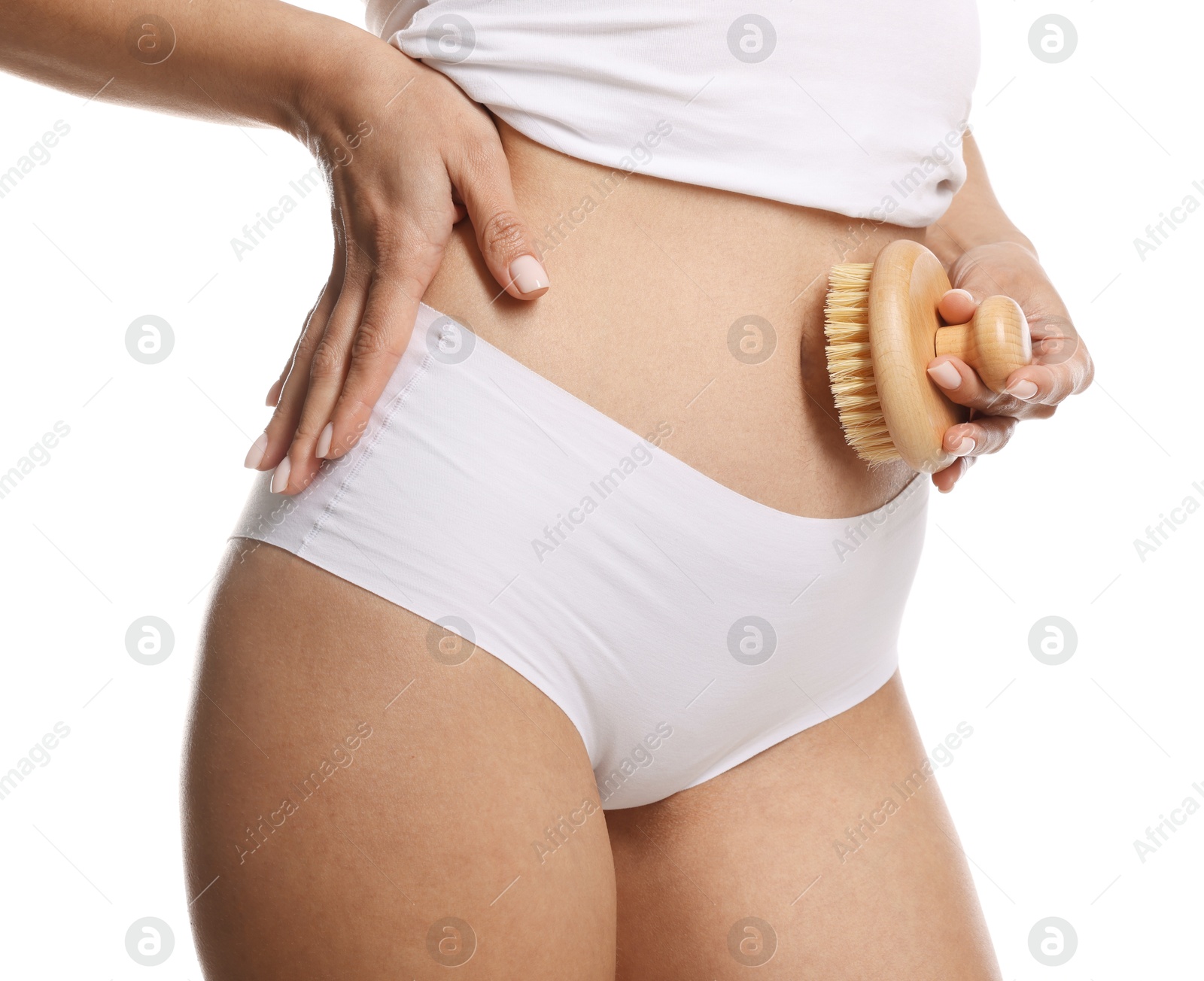 Photo of Woman doing anti cellulite massage with brush on white background, closeup