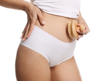 Photo of Woman doing anti cellulite massage with brush on white background, closeup