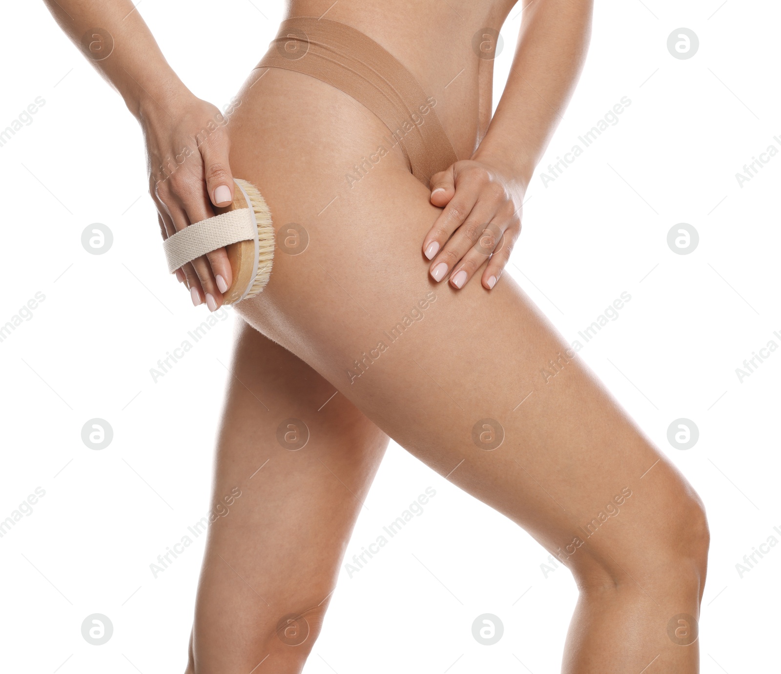 Photo of Woman doing anti cellulite massage with brush on white background, closeup