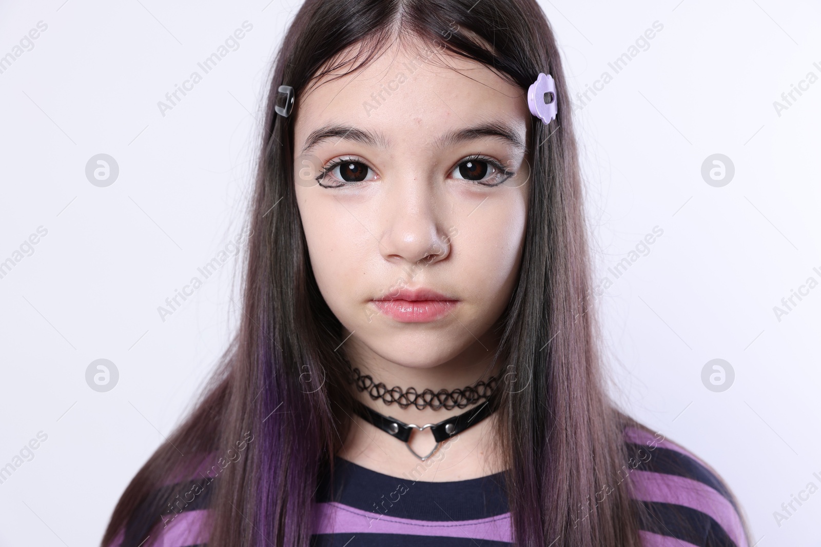 Photo of Teenage girl in stylish clothes and accessories posing on white background. Makeup in anime style