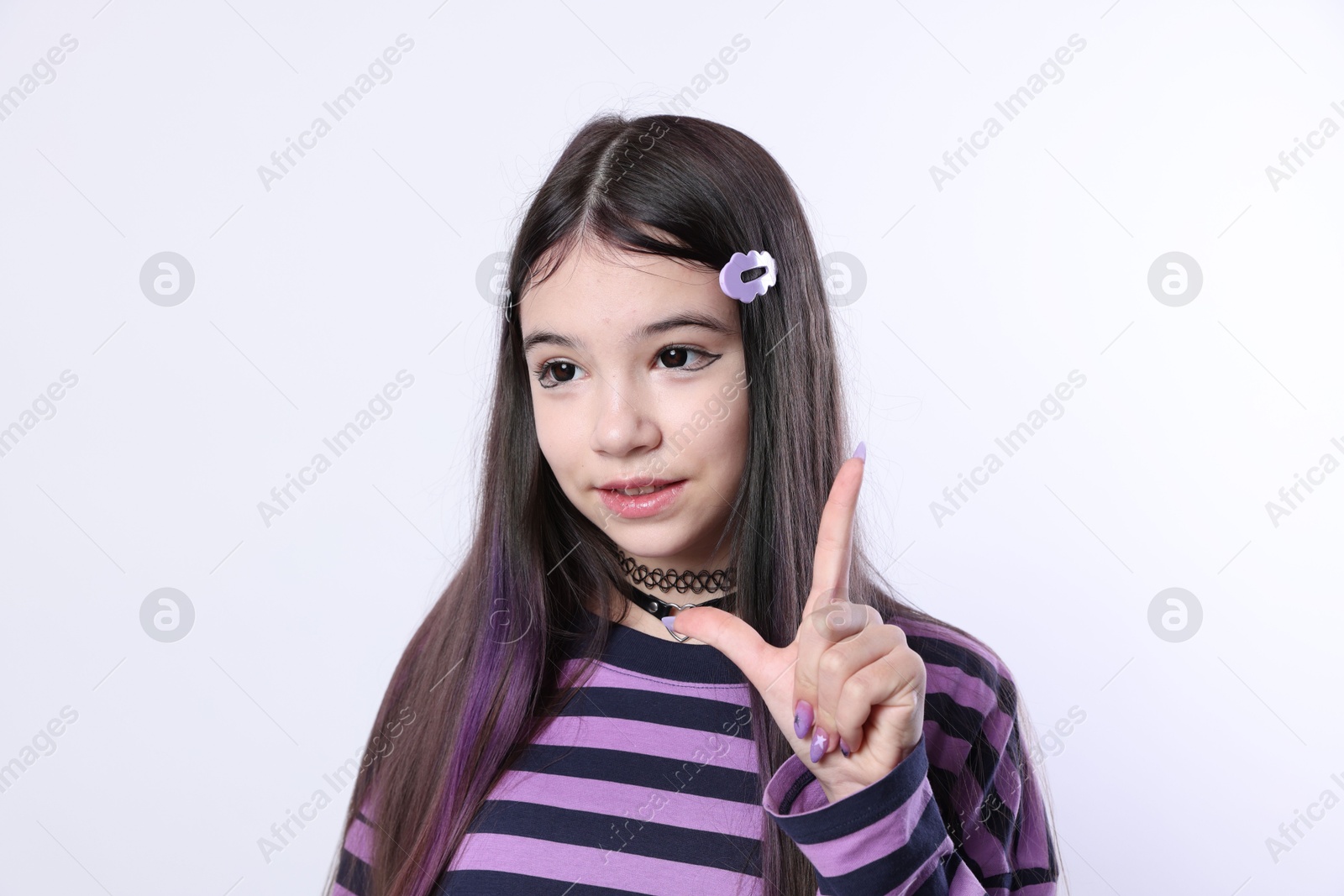 Photo of Teenage girl in stylish clothes and accessories posing on white background. Makeup in anime style