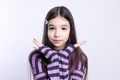 Photo of Teenage girl in stylish clothes and accessories posing on white background. Makeup in anime style