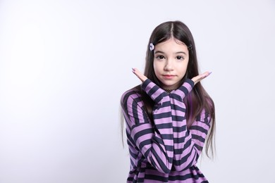 Photo of Teenage girl in stylish clothes and accessories posing on white background. Makeup in anime style