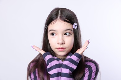 Photo of Teenage girl in stylish clothes and accessories posing on white background. Makeup in anime style