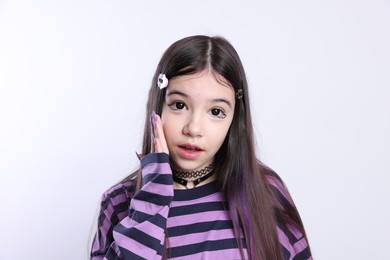 Teenage girl in stylish clothes and accessories posing on white background. Makeup in anime style